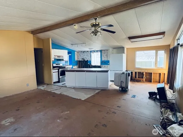 a living room with stainless steel appliances kitchen island granite countertop furniture and a kitchen view