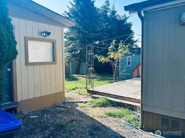 a view of a house with backyard and sitting area