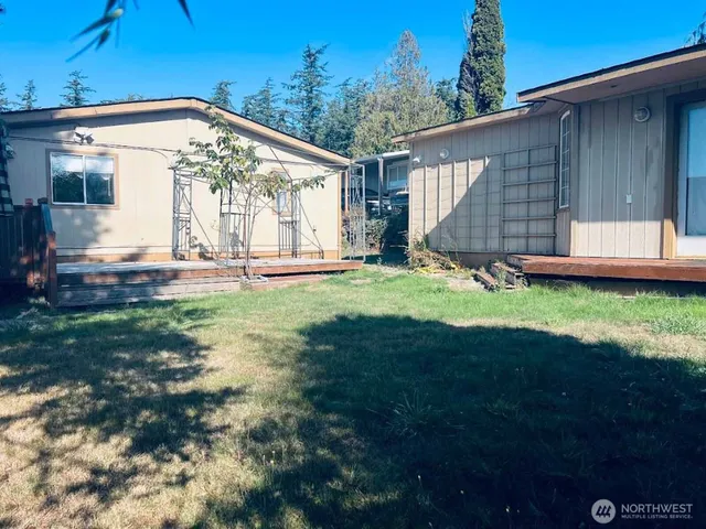 a view of a house with backyard and sitting area