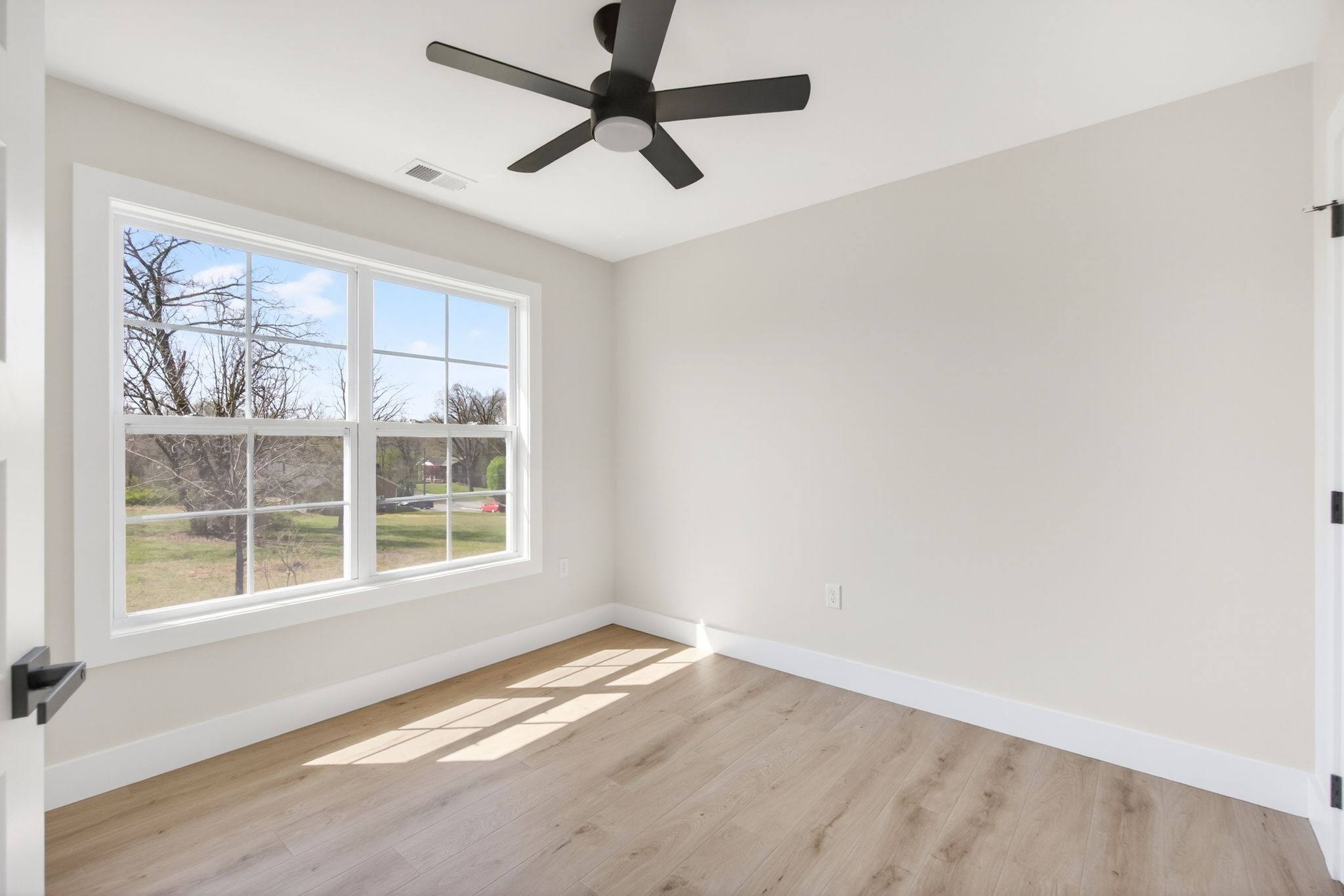 216 West Jere Whitson Road Cookeville, TN 38501 - Photo 26 of 31 an empty room with wooden floor and windows