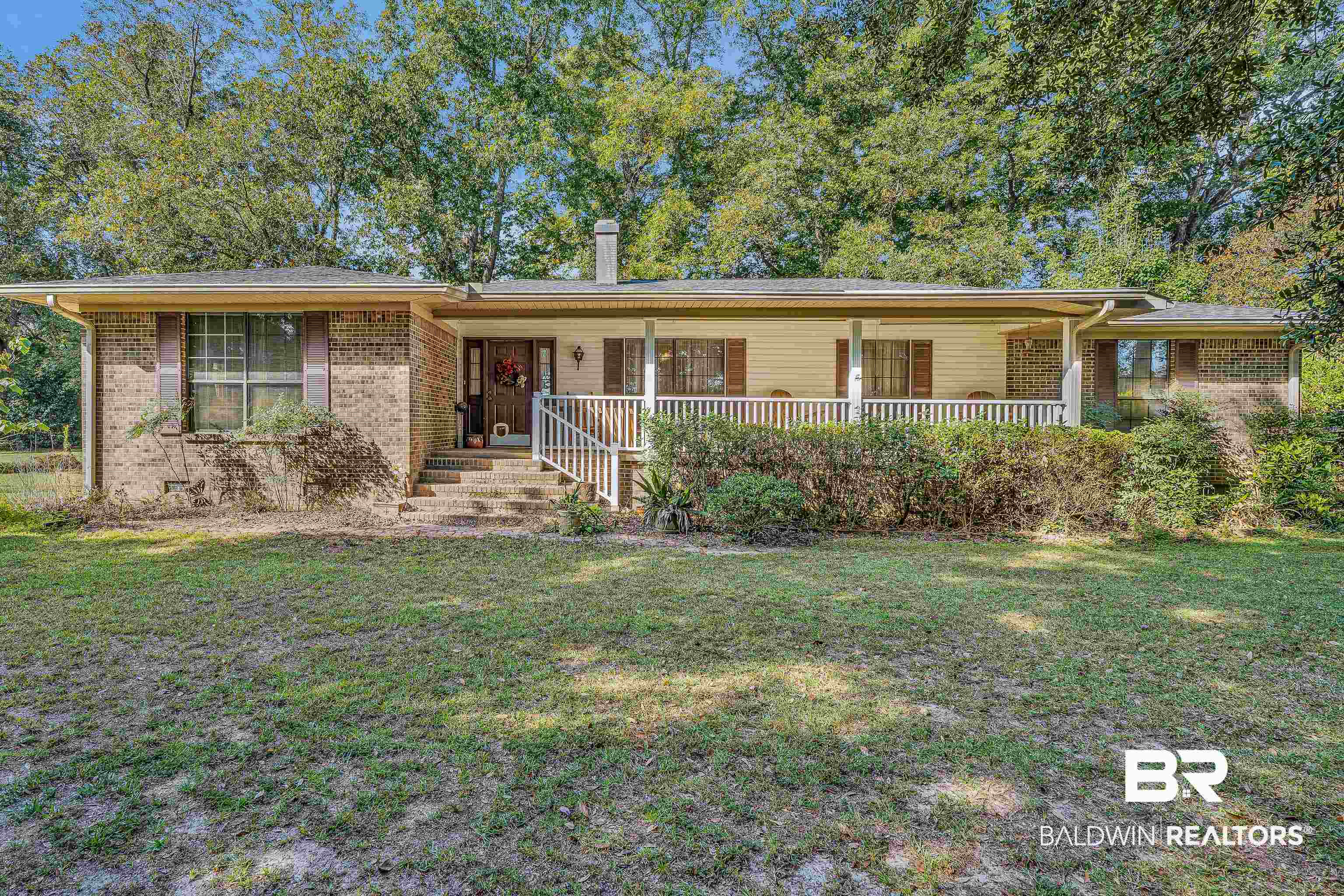 72075 Highway 59 Little River, AL 36550 - Photo 1 of 40 Ranch-style home with covered porch, a front lawn, and brick siding