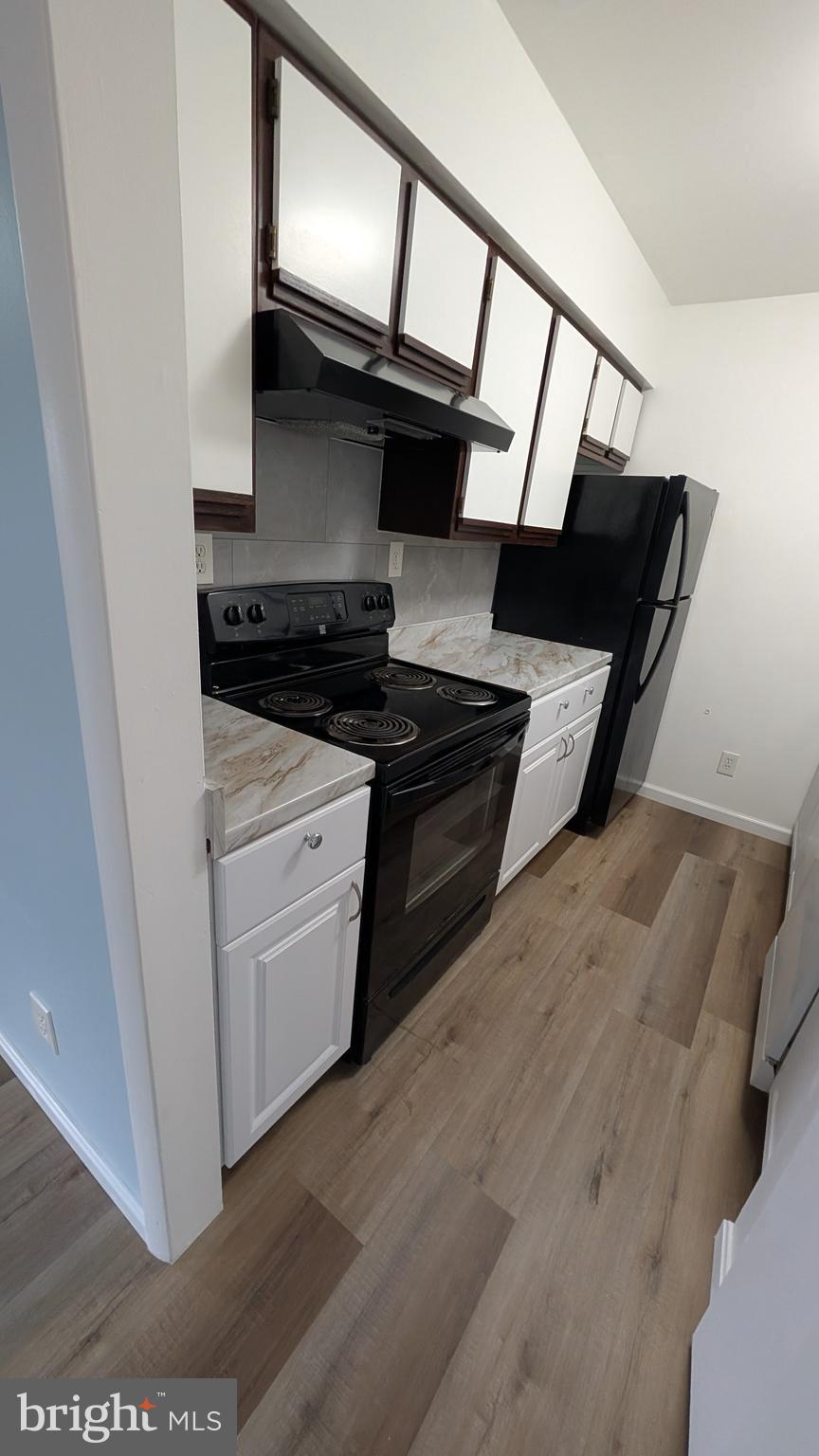 13402 Shady Knoll Drive, Unit 13402 Silver Spring, MD 20904 - Photo 12 of 22 a kitchen with a stove microwave and a sink
