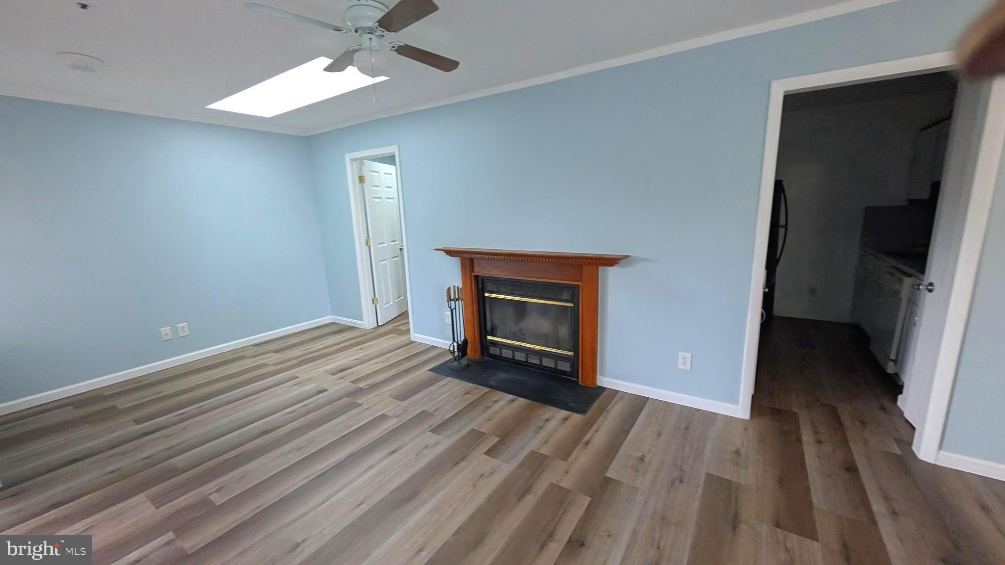13402 Shady Knoll Drive, Unit 13402 Silver Spring, MD 20904 - Photo 2 of 22 wooden floor fireplace and natural light in room