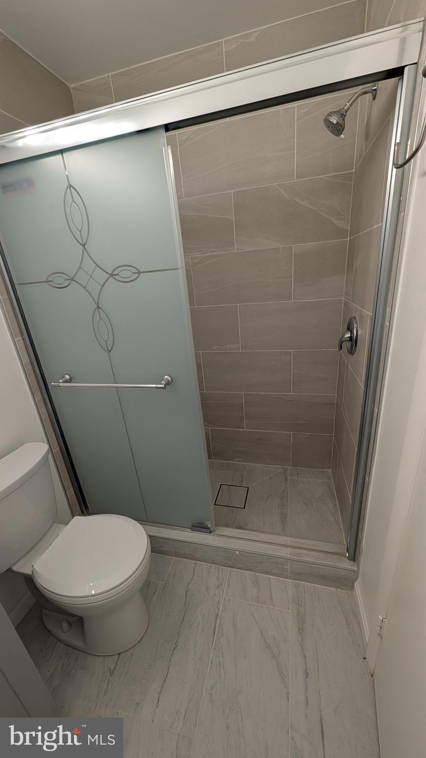 13402 Shady Knoll Drive, Unit 13402 Silver Spring, MD 20904 - Photo 21 of 22 a white toilet sitting next to a shower