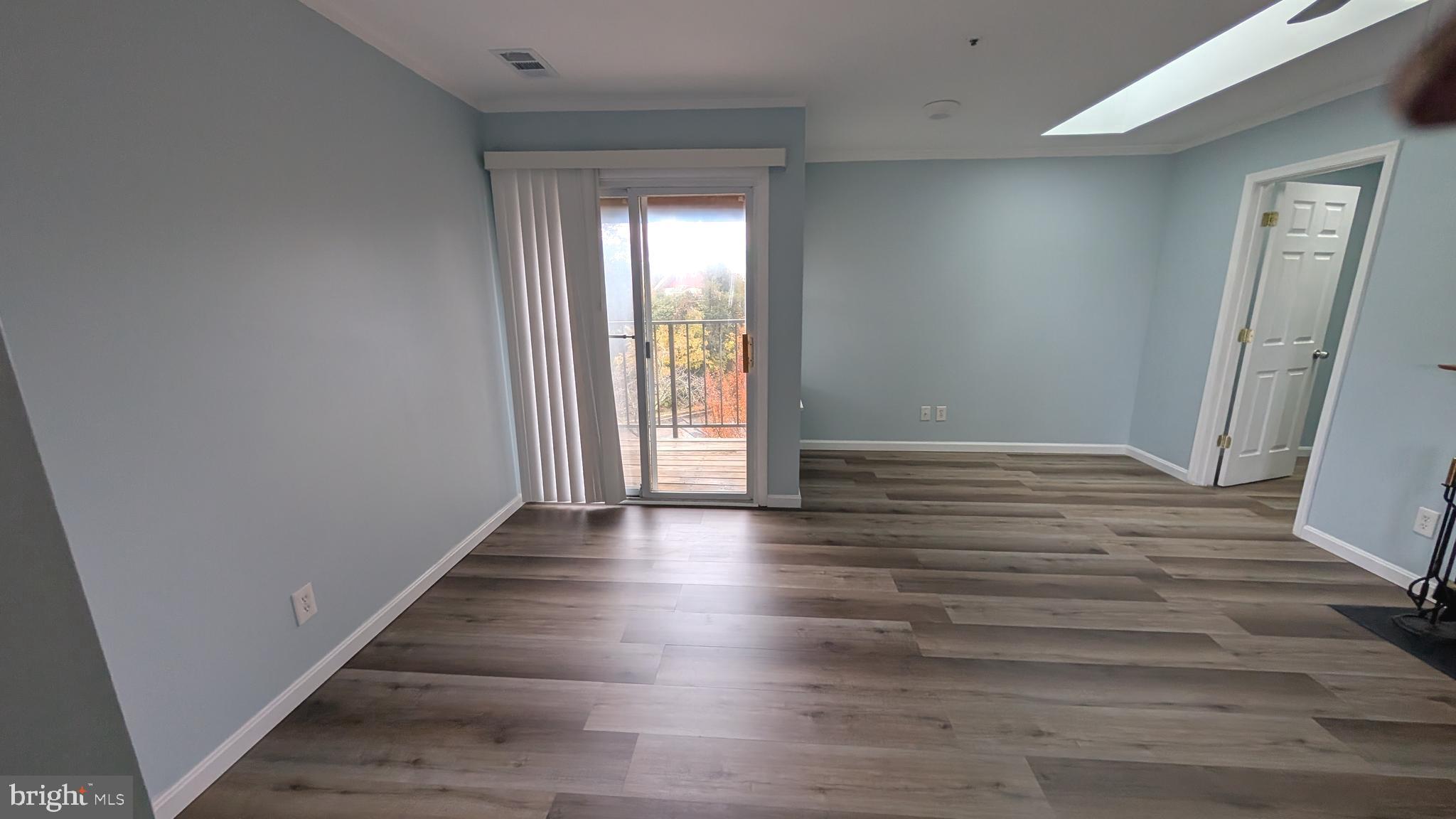 13402 Shady Knoll Drive, Unit 13402 Silver Spring, MD 20904 - Photo 6 of 22 wooden floor in an empty room with a window