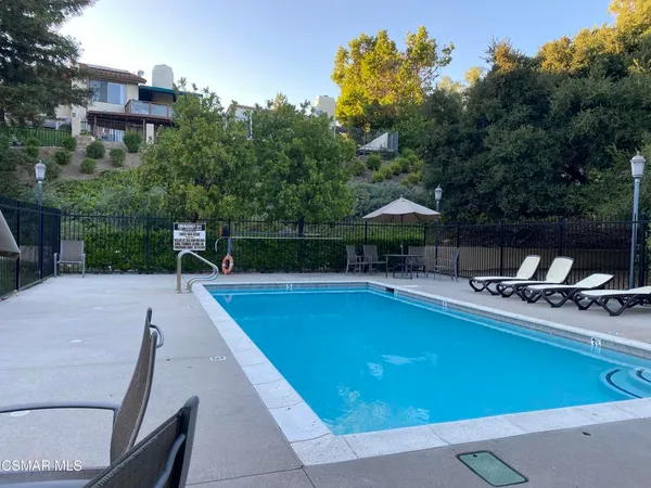 a view of a swimming pool with a lounge chair