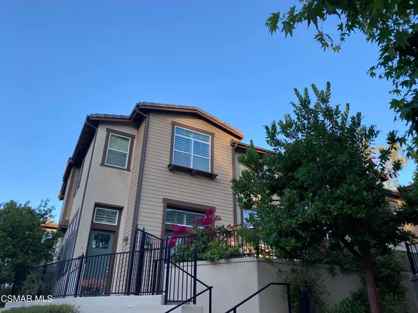 a front view of a house with plants