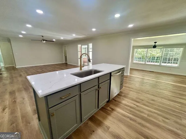 a kitchen with granite countertop a refrigerator stove and microwave
