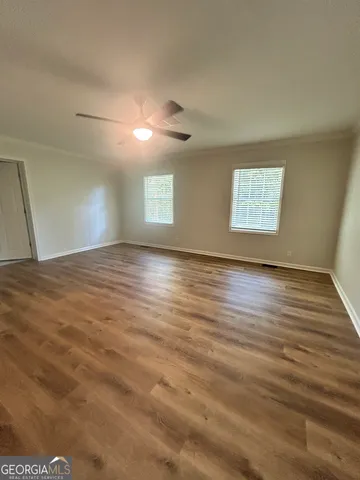 a bathroom with a granite countertop toilet sink and mirror
