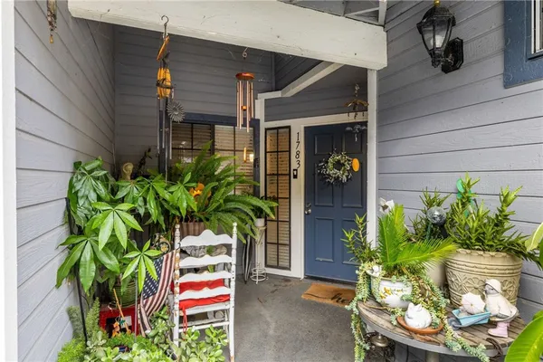 a plant hanging in front of a house
