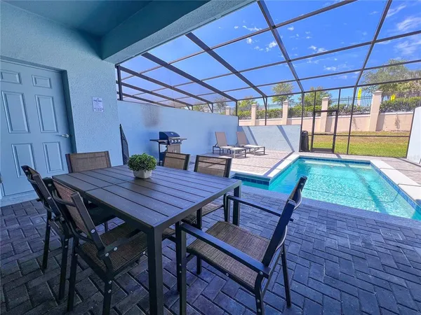 a outdoor dining space with furniture and wooden floor