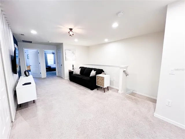 a kitchen with a sink a stove and a wooden floor