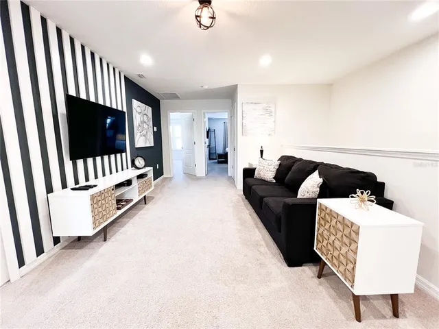 a bedroom with a bed window and a television