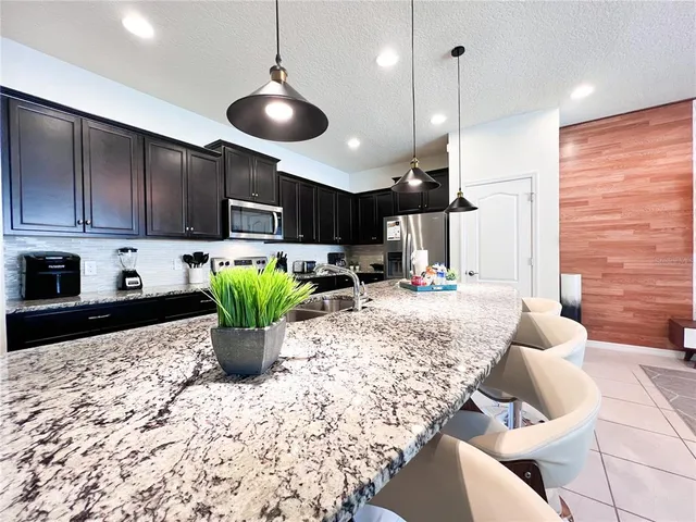 a kitchen with a stove a refrigerator and cabinets