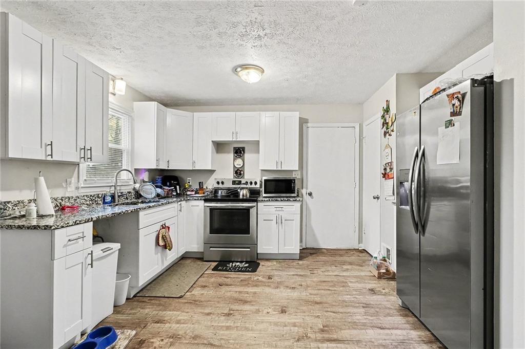 4494 Huntsman Bend Decatur, GA 30034 - Photo 12 of 27 a kitchen with a refrigerator sink and cabinets