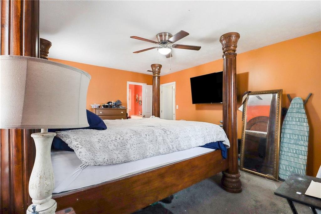 4494 Huntsman Bend Decatur, GA 30034 - Photo 16 of 27 a bedroom with a bed and a chandelier