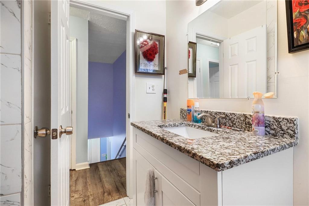 4494 Huntsman Bend Decatur, GA 30034 - Photo 20 of 27 a bathroom with a granite countertop sink and a mirror