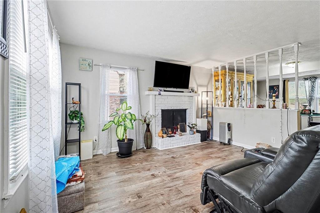 4494 Huntsman Bend Decatur, GA 30034 - Photo 8 of 27 a living room with furniture a flat screen tv and a fireplace