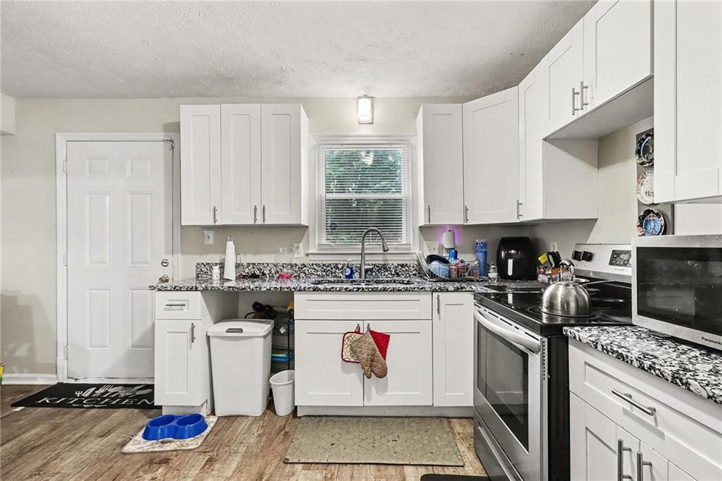 4494 Huntsman Bend Decatur, GA 30034 - Photo 10 of 27 a kitchen with a stove a sink and a refrigerator