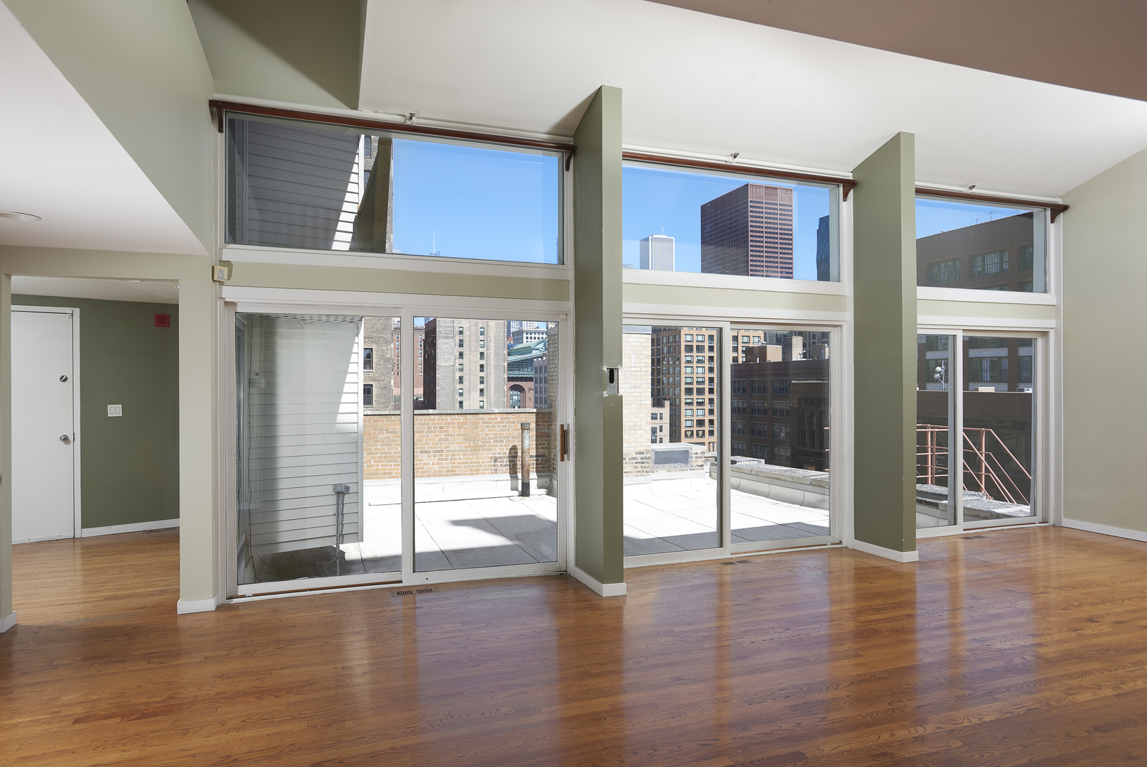 714 South Dearborn Street, Unit 9PH Chicago, IL 60605 - Photo 5 of 26 a view of a big room with wooden floor and windows