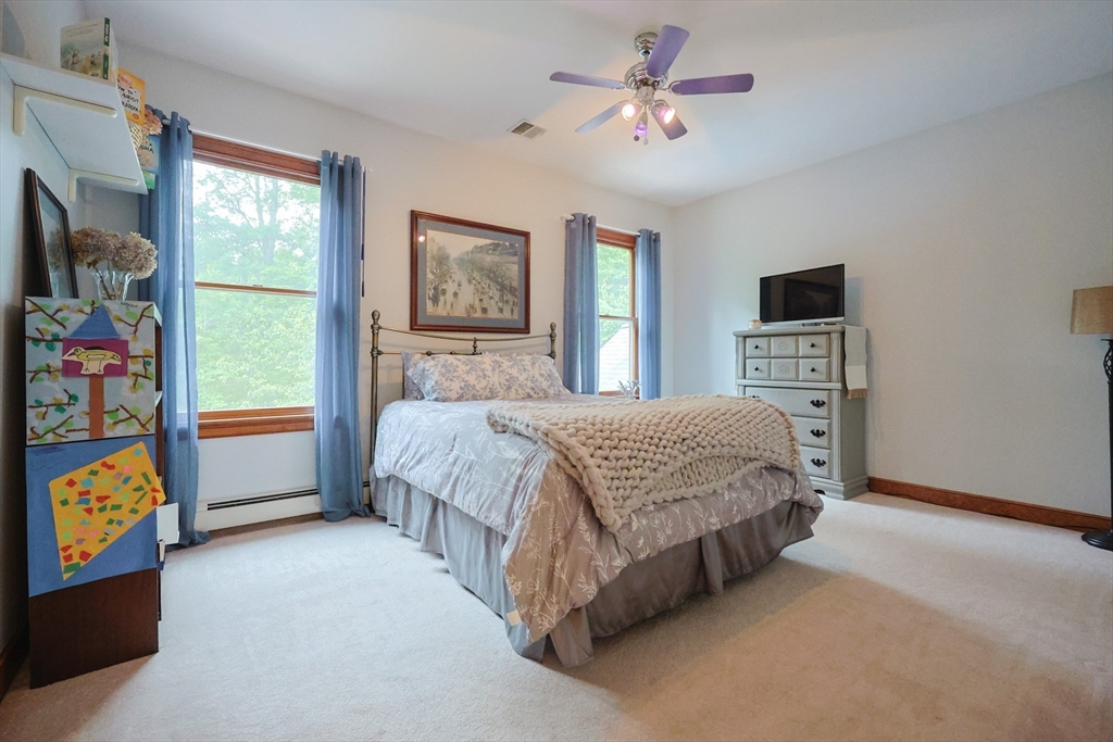 70 Azalea Way Hanson, MA 02341 - Photo 32 of 42 a spacious bedroom with a bed a dresser and a window