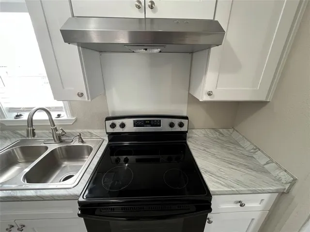 a close view of a sink and dishwasher in kitchen with stainless steel appliances