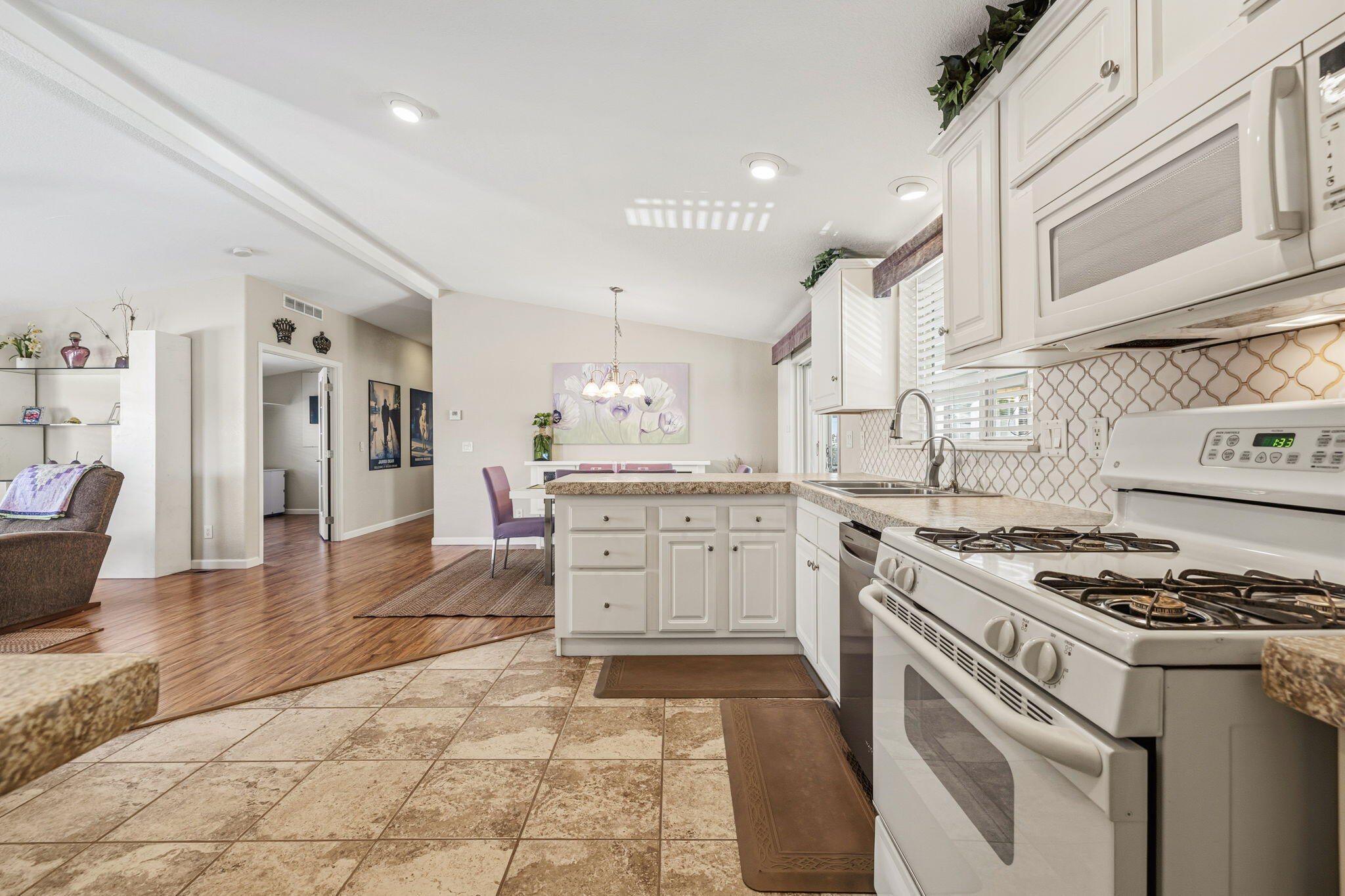 34960 Serenade Thousand Palms, CA 92276 - Photo 18 of 50 a kitchen with stainless steel appliances granite countertop a stove and a sink