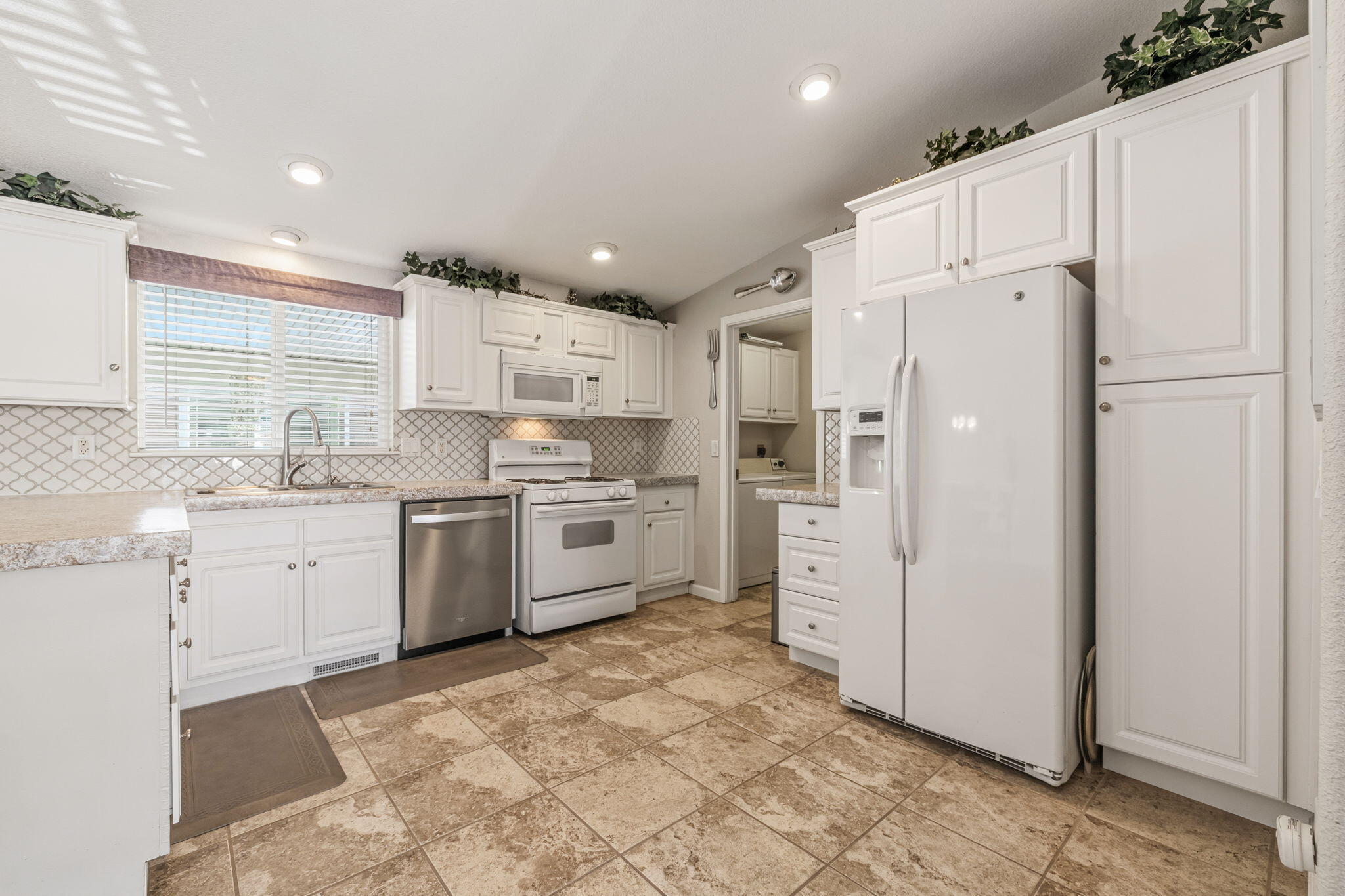 34960 Serenade Thousand Palms, CA 92276 - Photo 20 of 50 a kitchen with white cabinets and white stainless steel appliances