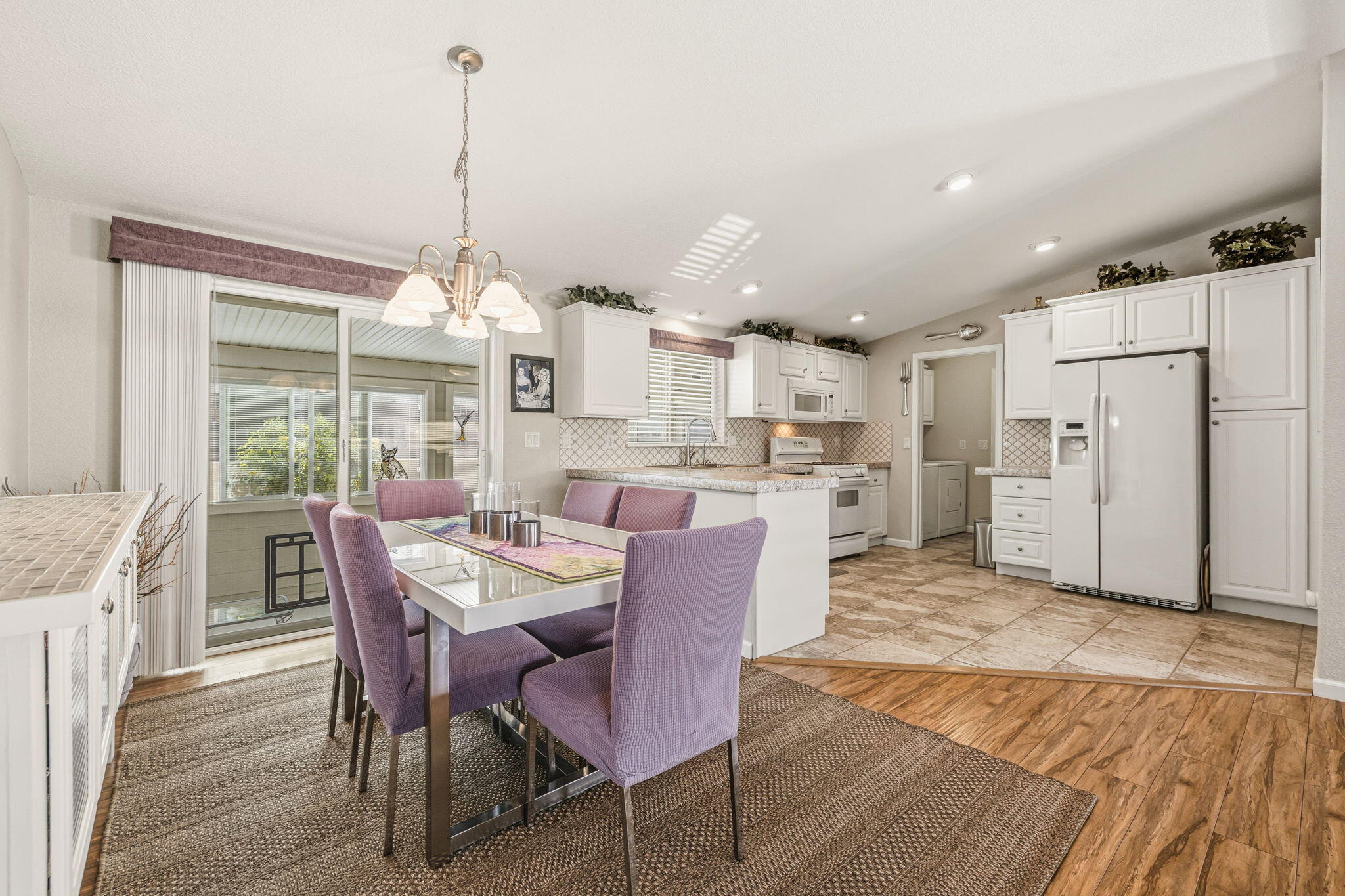 34960 Serenade Thousand Palms, CA 92276 - Photo 22 of 50 a dining room with furniture a chandelier and wooden floor