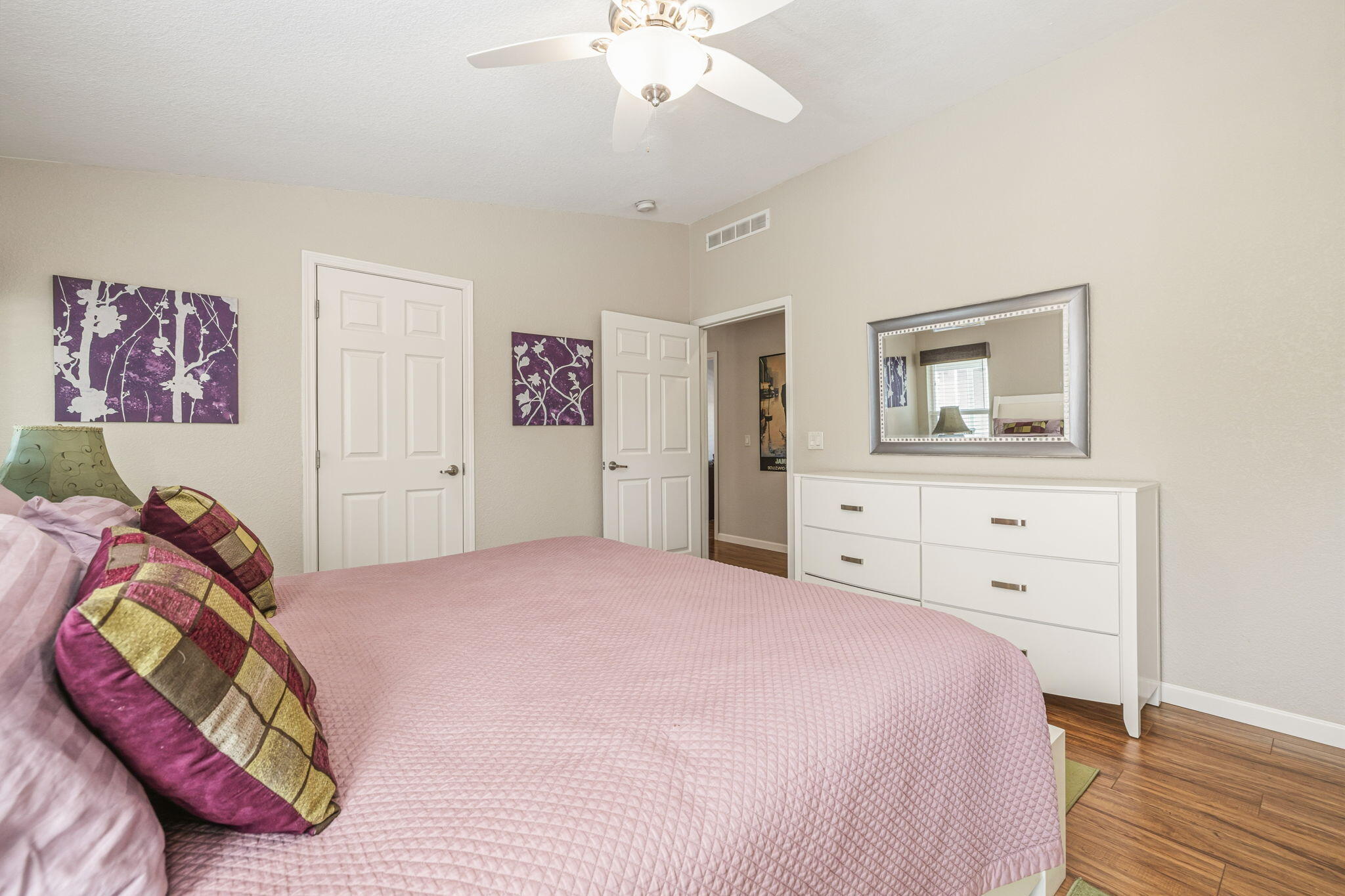 34960 Serenade Thousand Palms, CA 92276 - Photo 25 of 50 a bedroom with a bed and a chandelier