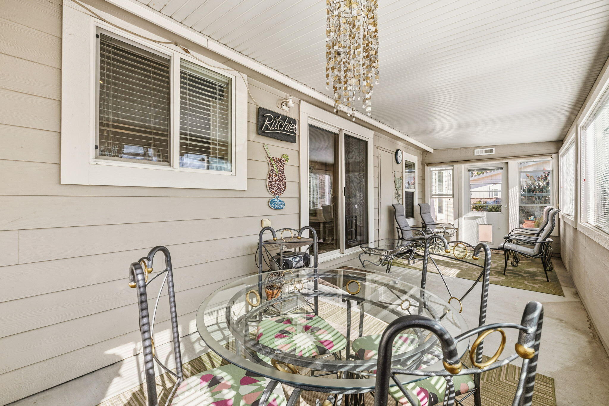 34960 Serenade Thousand Palms, CA 92276 - Photo 39 of 50 a dining room with furniture floor to ceiling windows and a chandelier