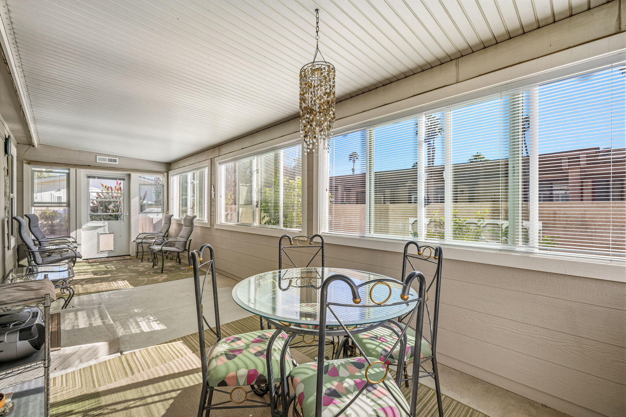34960 Serenade Thousand Palms, CA 92276 - Photo 40 of 50 a view of a dining room with furniture large windows and wooden floor