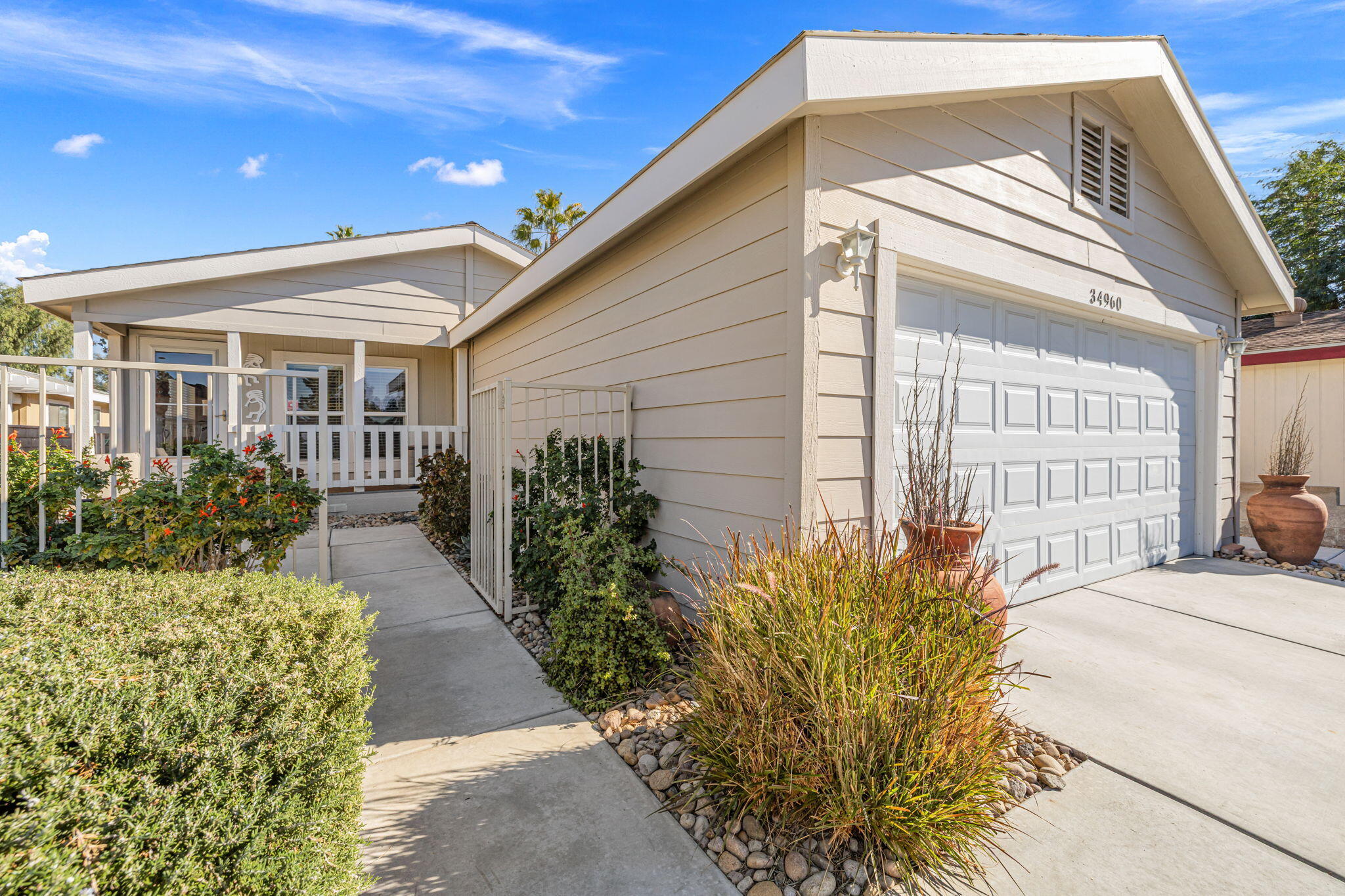 34960 Serenade Thousand Palms, CA 92276 - Photo 5 of 50 a front view of a house with garden