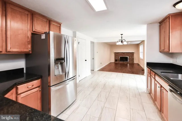 a kitchen with granite countertop stainless steel appliances and wooden cabinets
