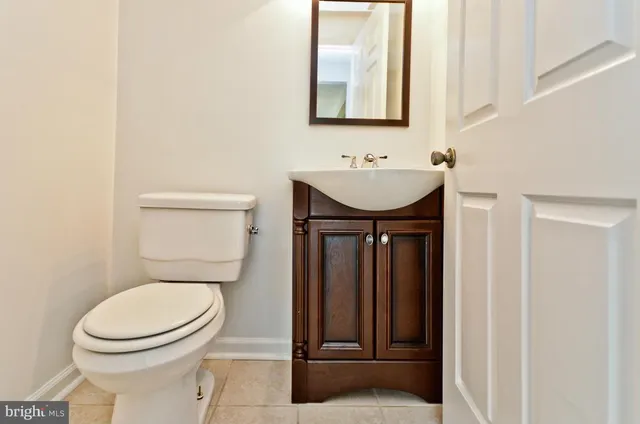 a bathroom with a toilet a sink and mirror