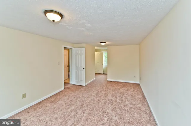 an empty room with a carpet