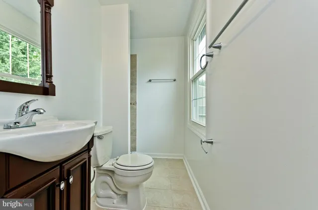 a bathroom with a sink toilet and mirror