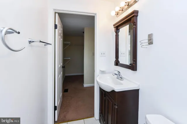 a bathroom with a sink vanity granite and a mirror
