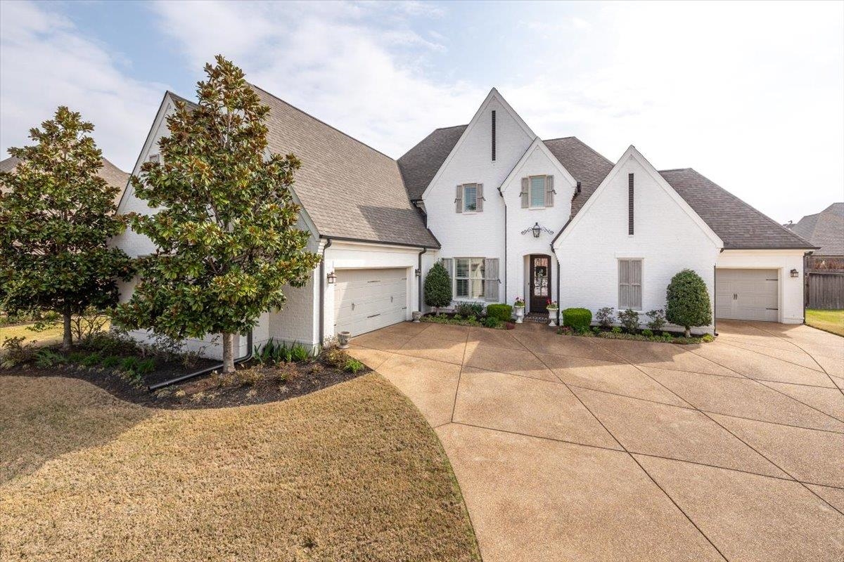 608 Cypress Run Cove Collierville, TN 38017 - Photo 38 of 40 View of front of property with roof with shingles, driveway, a front lawn, and an attached garage
