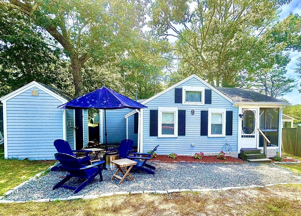 a view of a house with backyard porch and sitting area