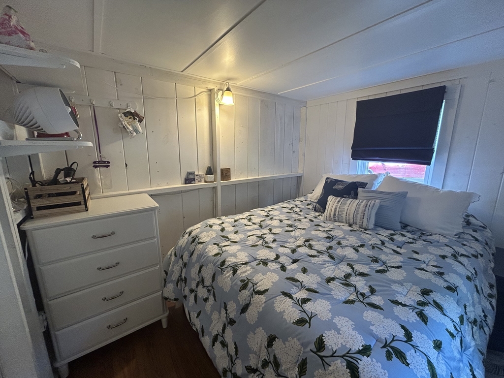 262 Old Wharf Road, Unit 67 Dennis, MA 02639 - Photo 11 of 36 a bedroom with a bed and a flat screen tv