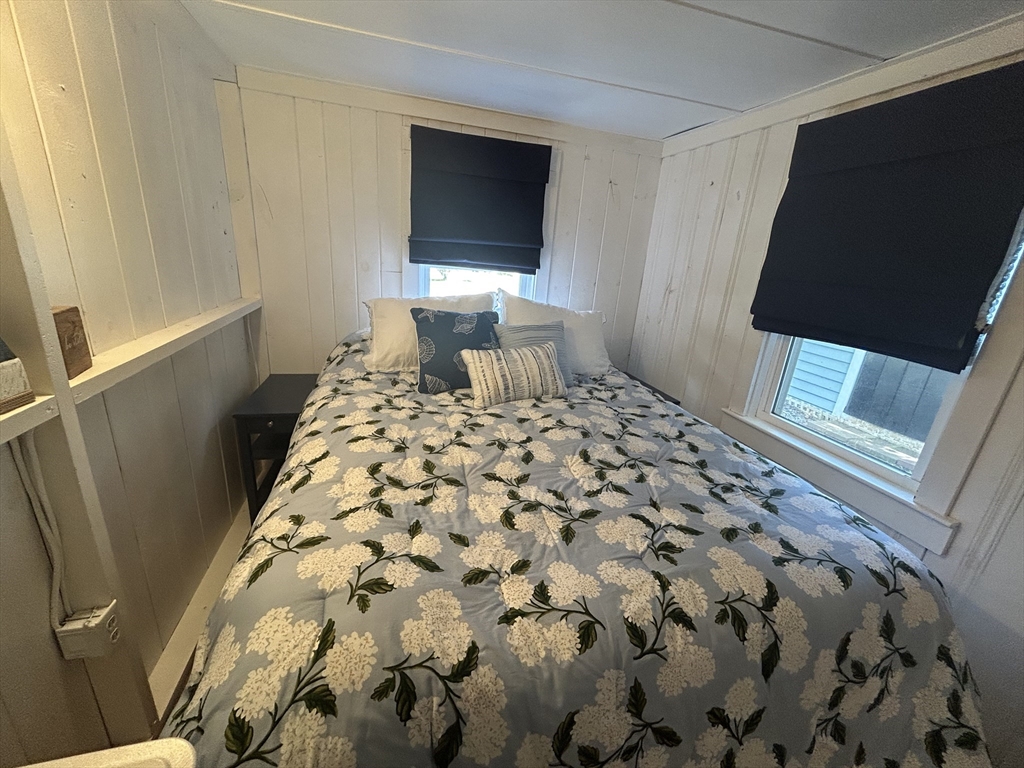 262 Old Wharf Road, Unit 67 Dennis, MA 02639 - Photo 12 of 36 a bedroom with a bed and a flat screen tv