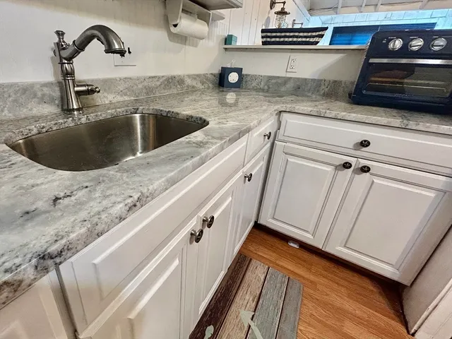 a kitchen with granite countertop a sink and a stove