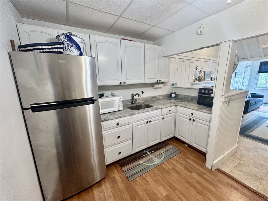 262 Old Wharf Road, Unit 67 Dennis, MA 02639 - Photo 15 of 36 a kitchen with stainless steel appliances a refrigerator sink and cabinets