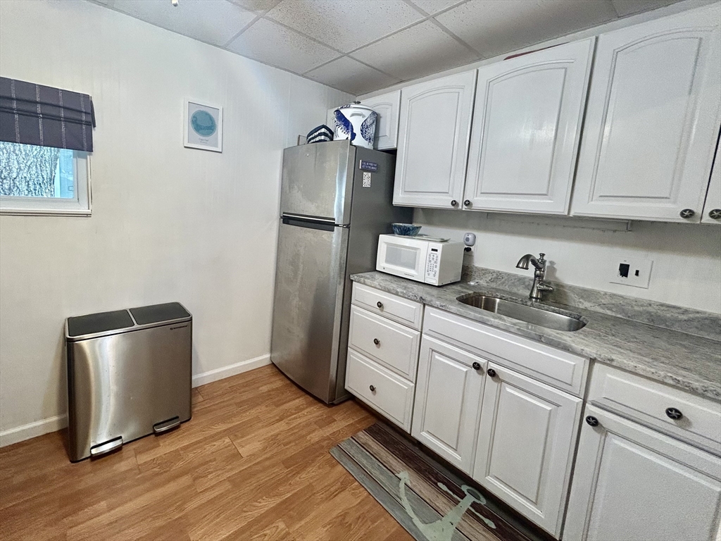 262 Old Wharf Road, Unit 67 Dennis, MA 02639 - Photo 16 of 36 a kitchen with stainless steel appliances granite countertop a refrigerator sink and cabinets