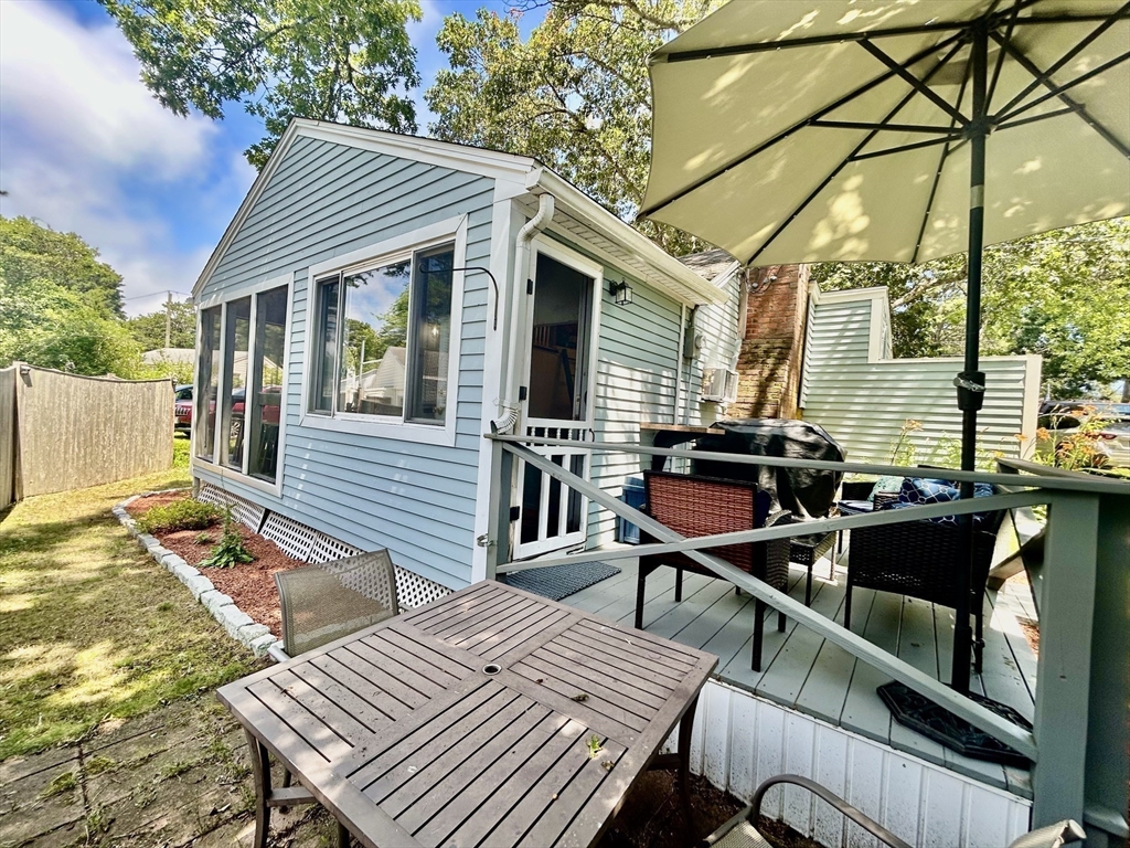 262 Old Wharf Road, Unit 67 Dennis, MA 02639 - Photo 27 of 36 a view of a patio with wooden floor
