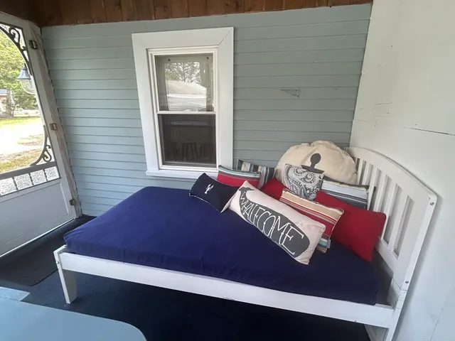 a view of a bedroom with furniture and window