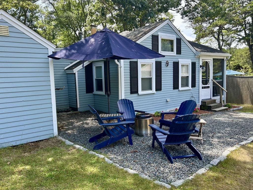 262 Old Wharf Road, Unit 67 Dennis, MA 02639 - Photo 35 of 36 a front view of a house with patio outdoor seating