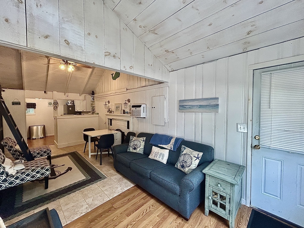 262 Old Wharf Road, Unit 67 Dennis, MA 02639 - Photo 7 of 36 a living room with furniture and wooden floor