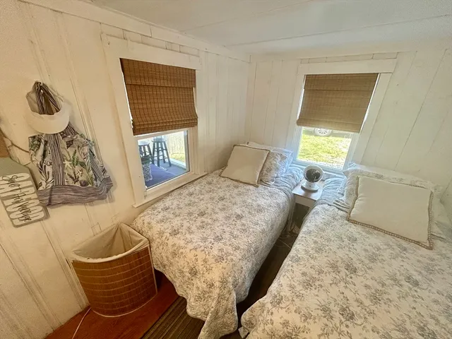 a bedroom with a bed and next to a window